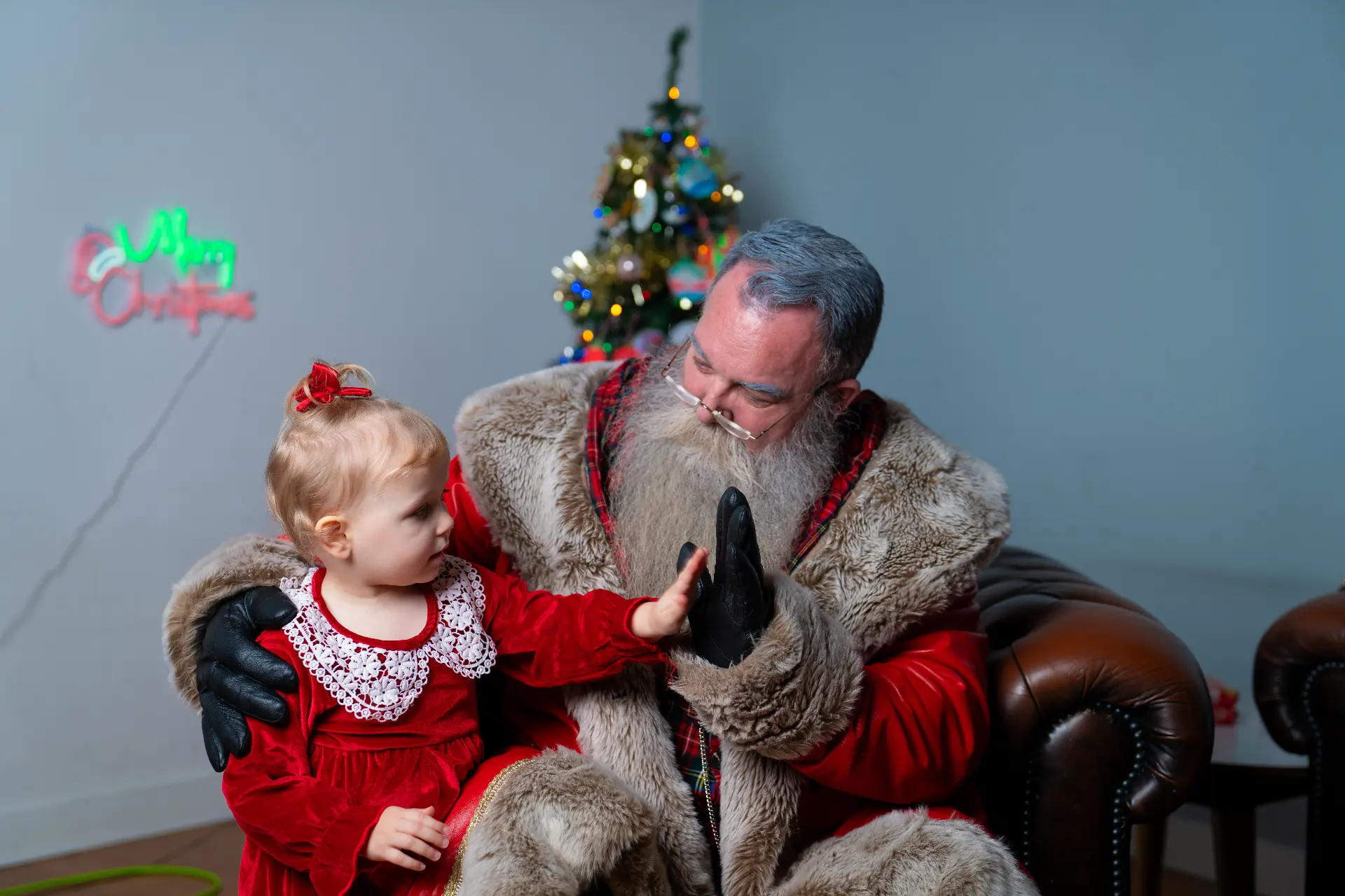 Santa high-fiving a child